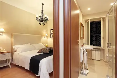 a bedroom with a bed and a chandelier at Daplace - Ottavia Apartment in Rome