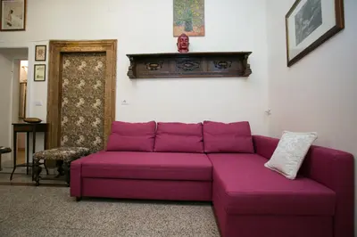 a purple couch sitting in a living room at Vicolo Vecchio 59 in Rome