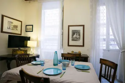 a dining room with a table with blue plates on it at Vicolo Vecchio 59 in Rome