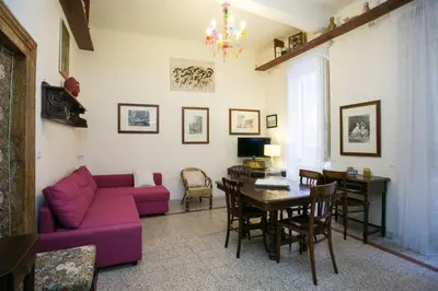 a living room with a purple couch and a table at Vicolo Vecchio 59 in Rome