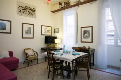 a living room with a table with chairs and a couch at Vicolo Vecchio 59 in Rome