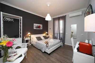 a bedroom with a bed and a living room at A 2 Passi Dai Musei Luxury Guest House in Rome