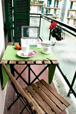 a table and a chair on a balcony with a table and a cup at S Peter Nicolo' III in Rome