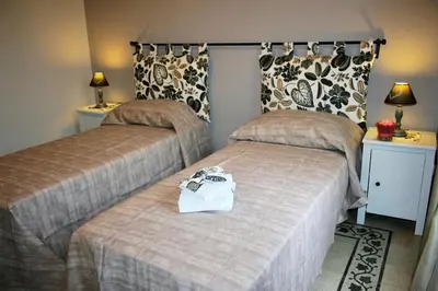 a hotel room with two beds with a purse on the bed at S Peter Nicolo' III in Rome