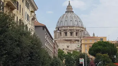 a building with a dome on top of a city at S Peter Nicolo' III in Rome