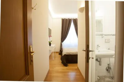 a bathroom with a sink and a bed in a room at InnsideRome in Rome