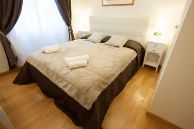 a bedroom with a large bed with two pillows on it at InnsideRome in Rome