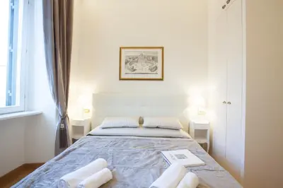 a bedroom with a bed with two towels on it at InnsideRome in Rome