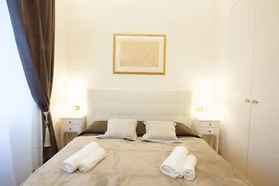 a bedroom with a bed with two white towels on it at InnsideRome in Rome