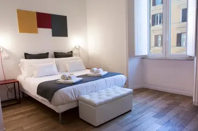 a bedroom with a bed with two towels on it at Suite Cardinale in Rome