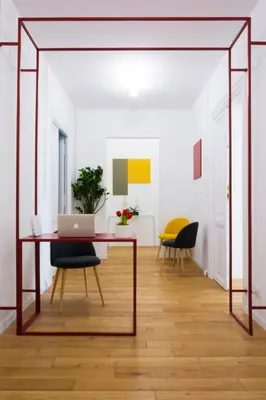 a dining room with a table and a laptop at Suite Cardinale in Rome