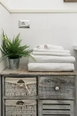 a wooden dresser with towels and a plant on it at Tevere Rome Apartments in Rome
