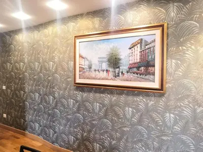 a painting hanging on a wall with a mural at Tevere Rome Apartments in Rome