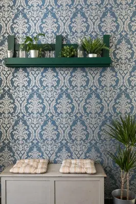 a room with blue wallpaper and shelves with plants at Tevere Rome Apartments in Rome