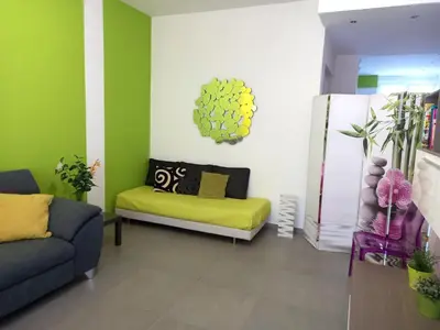 a living room with green walls and a couch at Lungotevere Holidays in Rome