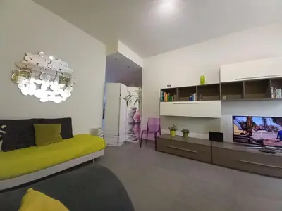 a living room with a bed and a television at Lungotevere Holidays in Rome
