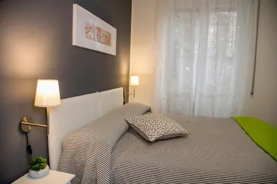 a bedroom with a bed with a pillow and a window at Mikasa Piazza Bologna in Rome