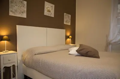 a bedroom with a bed with two tables and two lamps at Mikasa Piazza Bologna in Rome