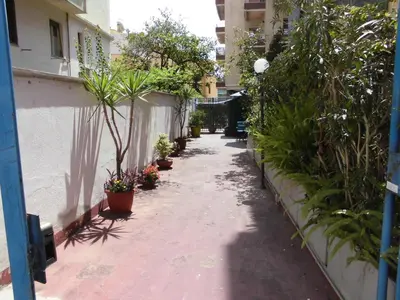 a walkway with potted plants on the side of a building at Mikasa Piazza Bologna in Rome