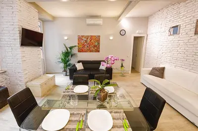 a living room with a couch and a table at Modern Apartment near Colosseum in Rome