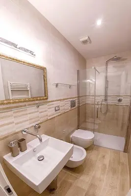 a bathroom with a sink and a toilet and a shower at Modern Apartment near Colosseum in Rome