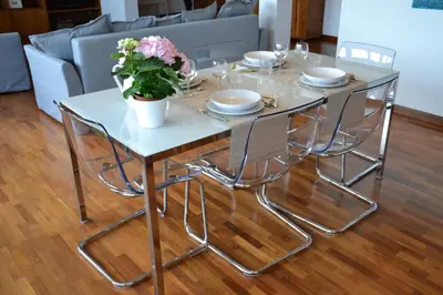 a white table with chairs and a vase of flowers on it at Penthouse Cardello Colosseum in Rome