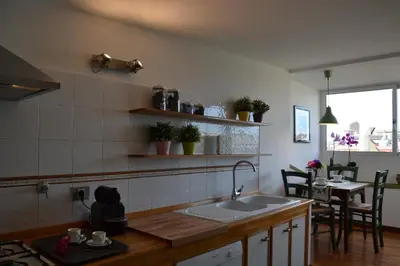 a kitchen with a sink and a table with chairs at Penthouse Cardello Colosseum in Rome