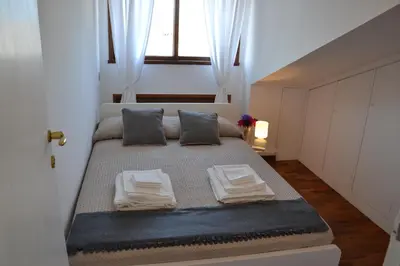 a bedroom with a bed with towels on it at Penthouse Cardello Colosseum in Rome