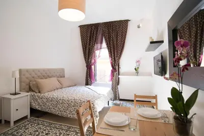 a small apartment with a bed and a table and chairs at Justa casa Borgo Vittorio in Rome