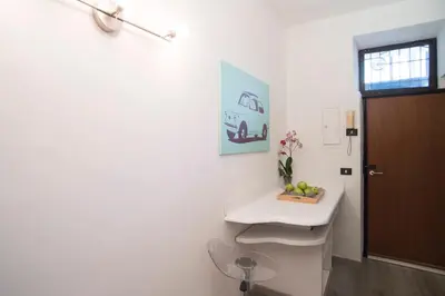 a white bathroom with a sink and a door at Justa casa Borgo Vittorio in Rome