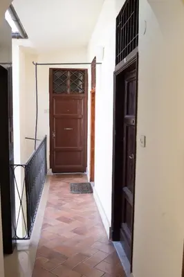 a hallway with a wooden door and a staircase at Justa casa Borgo Vittorio in Rome