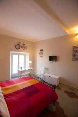 a bedroom with a bed and a bike on the wall at Alloggio Quiriti in Rome