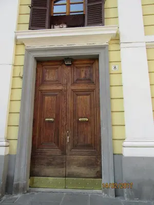 a wooden door on the side of a building at Alloggio Quiriti in Rome