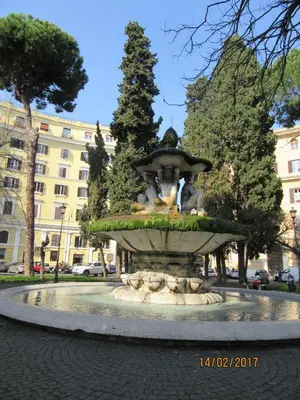 a fountain in the middle of a city at Alloggio Quiriti in Rome