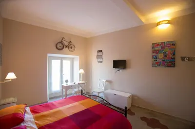 a bedroom with a bed and a desk with a bike on the wall at Alloggio Quiriti in Rome
