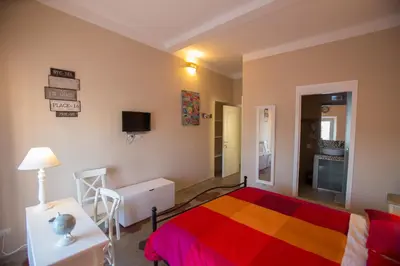 a bedroom with a bed with a colorful blanket at Alloggio Quiriti in Rome