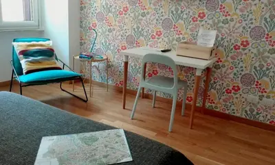 a room with a desk and a chair and a table at La Controra Guesthouse Roma in Rome