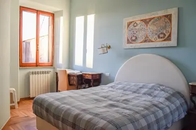 a bedroom with a bed with a plaid blanket at Penthouse Angelo Brunetti in Rome