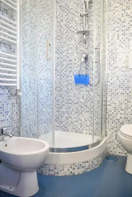 a bathroom with a shower with a toilet and a sink at Penthouse Angelo Brunetti in Rome