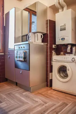 a kitchen with a stove and a washing machine at Penthouse Angelo Brunetti in Rome