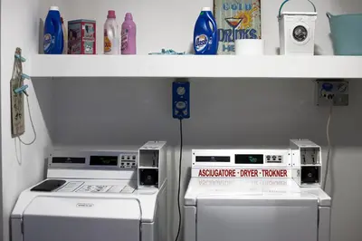 two machines sitting under a shelf in a kitchen at Hostel Trastevere in Rome