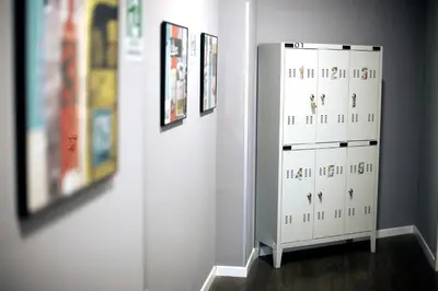a white cabinet in a room with pictures on the wall at Hostel Trastevere in Rome