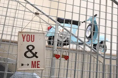 a sign that says you and me in front of a car at Hostel Trastevere in Rome