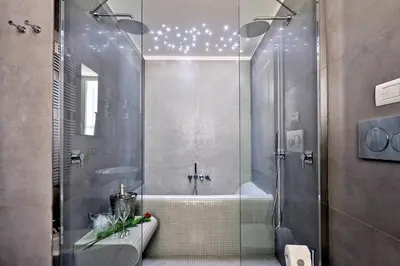 a bathroom with a shower and a tub with stars on the ceiling at Propaganda Suites in Rome