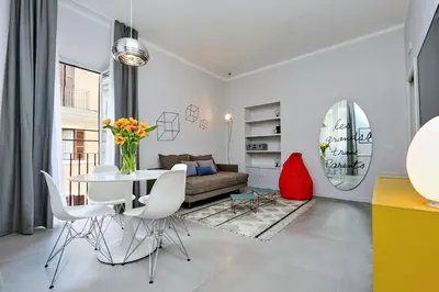a living room with a table and a couch at Propaganda Suites in Rome