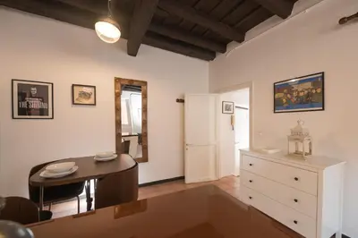 a living room with a table and a dresser at Al Cedro in Rome