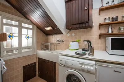 a kitchen with a washing machine and a sink at Al Cedro in Rome