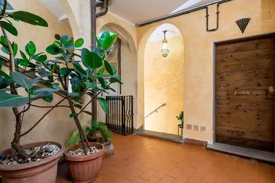 a hallway with potted plants and a wooden door at Al Cedro in Rome