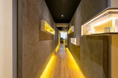 a long hallway with a light on the wall at Maison Pellegrino in Rome
