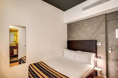 a small bedroom with a bed in a room at Maison Pellegrino in Rome
